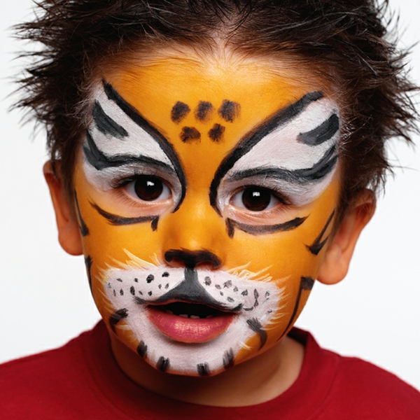 Boy (3-5) with face painted as tiger, close-up, portrait